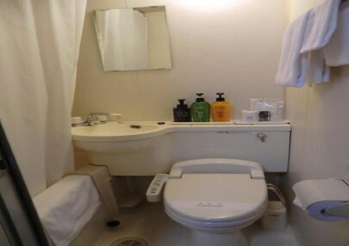 a small bathroom with a toilet and a sink at Azu garden Nippombashi / Vacation STAY 74141 in Osaka