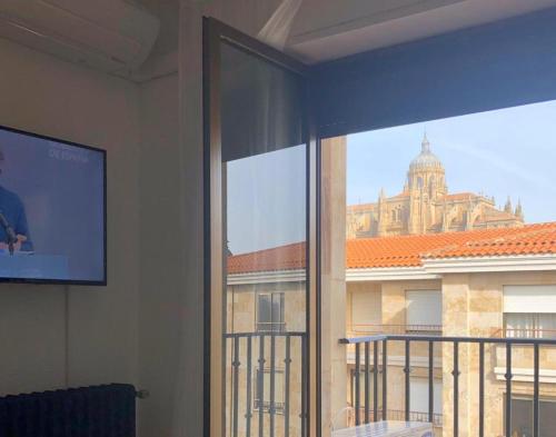 a room with a window with a view of a building at LOFT ESTUDIO CATEDRAL CASA LIS in Salamanca