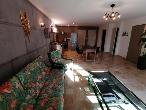 a living room with a couch and a glass table at Domaine de la Vidalle in Vendres