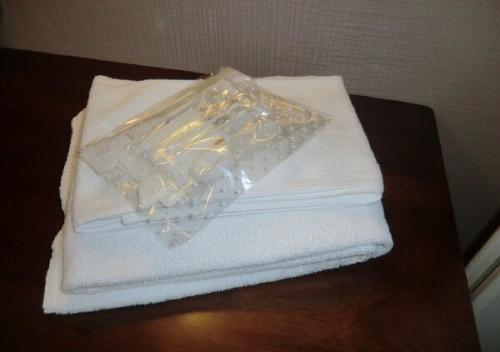 a pile of white towels sitting on a table at Azu garden Nippombashi / Vacation STAY 74141 in Osaka
