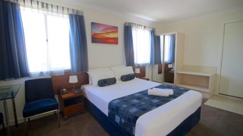 a hotel room with a bed and a chair at Pinnacles Edge Resort in Cervantes