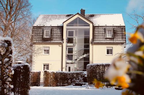 a house with a window in the snow at Hotel am Wallgraben in Brilon