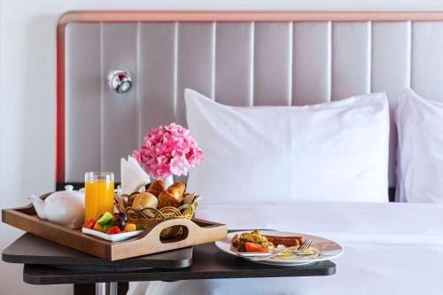 a tray of food on a table in a hotel room at Park Inn by Radisson Hotel and Residence Duqm in Duqm