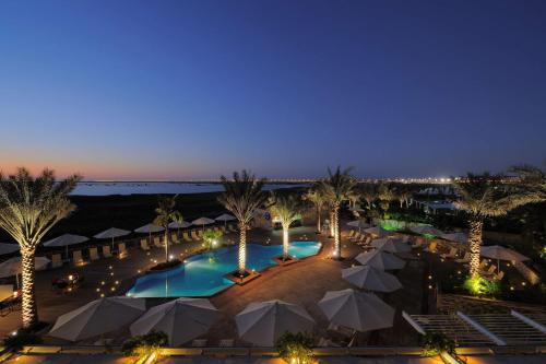 an aerial view of a resort pool at night at Park Inn by Radisson Abu Dhabi Yas Island in Abu Dhabi
