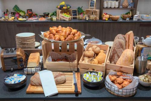 a display of bread and pastries on a table at Radisson Blu Hotel, Bruges in Bruges