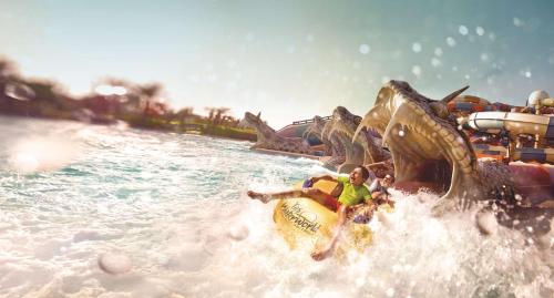 a group of people riding a roller coaster in the water at Radisson Blu Hotel, Abu Dhabi Yas Island in Abu Dhabi