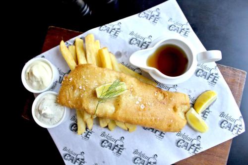 a plate with fish and french fries and dipping sauce at Radisson Blu Hotel, Abu Dhabi Yas Island in Abu Dhabi
