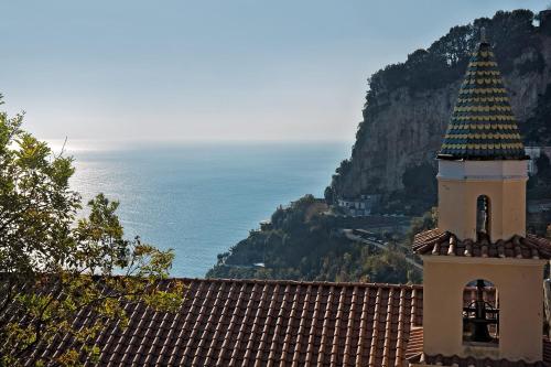a clock tower on top of a building with a view of the ocean at Villa Maria in Amalfi