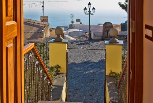 an open door to a balcony with a view of a street at Villa Maria in Amalfi