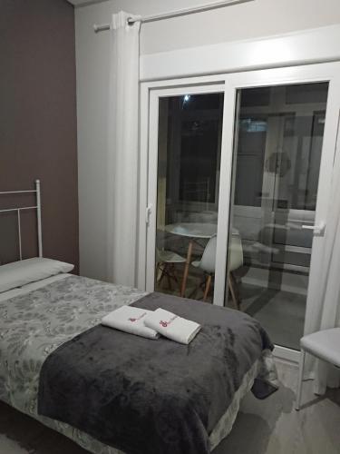 a bedroom with a bed with two towels on it at Pensión NAVIA A Pontenova in A Pontenova