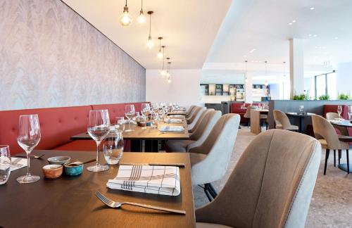 a dining room with a long table and chairs at Radisson Blu Hotel, Bruges in Bruges
