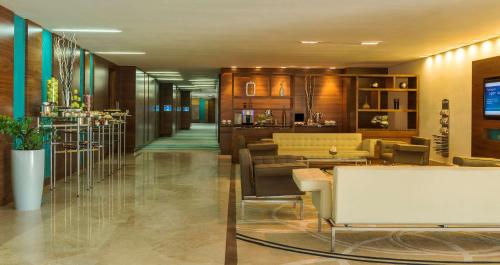 a lobby of a hotel with chairs and tables at Radisson Blu Hotel, Abu Dhabi Yas Island in Abu Dhabi