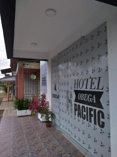 a hotel ocea pacific sign on the wall of a building at Hotel OBEGA PACIFIC in Nuquí