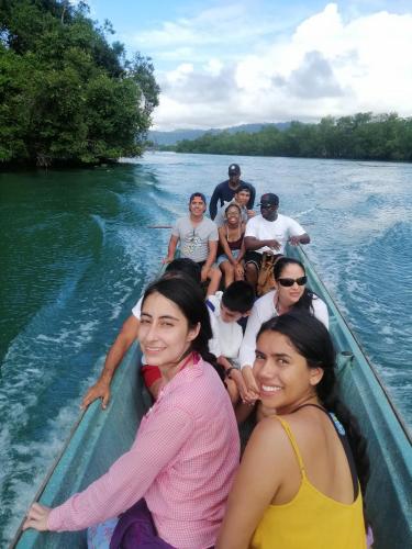 a group of people in a boat on a river at Hotel OBEGA PACIFIC in Nuquí