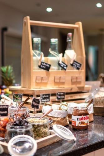 a counter with jars of food on a counter top at Park Inn by Radisson Nürnberg in Nuremberg