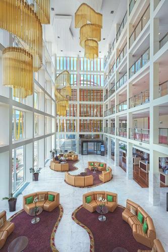a large lobby with couches and tables in a building at Radisson Blu Hotel & Convention Centre Kigali in Kigali