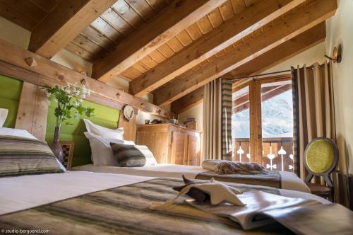 2 camas en una habitación con techos de madera en Résidence l'Oxalys en Val Thorens