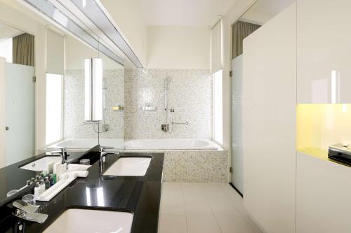 a bathroom with two sinks and a bath tub at Radisson Blu Hotel & Convention Centre Kigali in Kigali