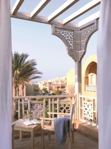 a patio with a table and chairs on a balcony at Radisson Blu Resort El Quseir in Quseir
