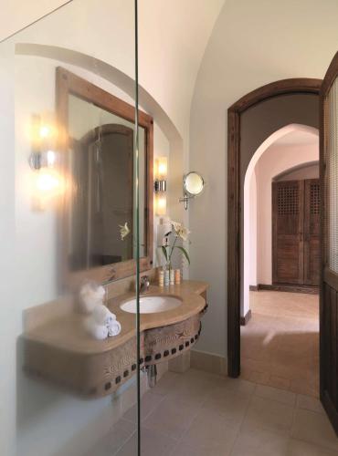 a bathroom with a sink and a mirror at Radisson Blu Resort El Quseir in Quseir