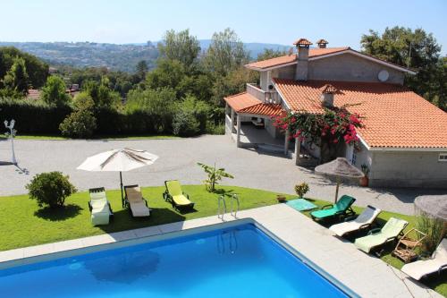 a villa with a swimming pool and a house at MARINHO'S - Vivenda Marinho in Porto