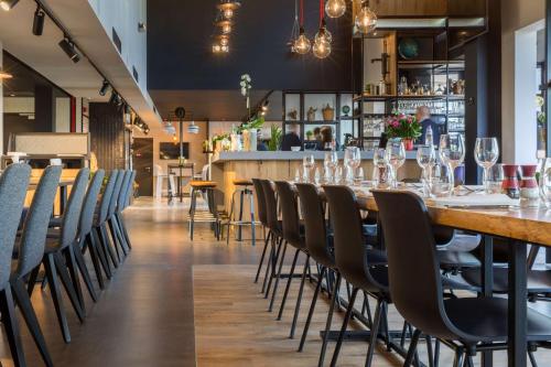 a dining room with a long table and chairs at Park Inn By Radisson Brussels Airport in Diegem