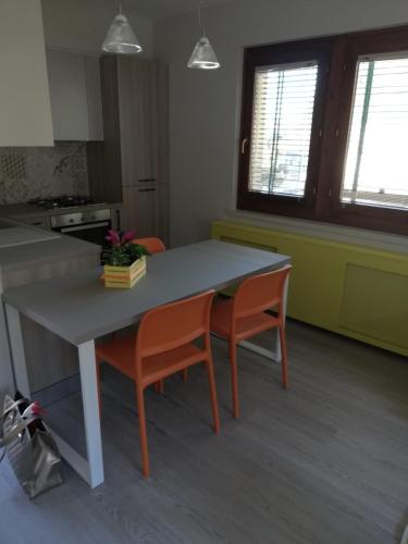 a kitchen with a table and two chairs at Alex's home 2 in Crone