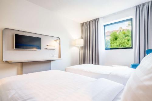 Postel nebo postele na pokoji v ubytování Park Inn by Radisson Danube Bratislava