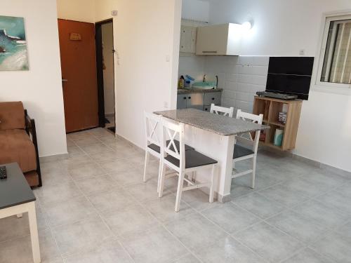 a kitchen with a table and chairs in a room at Nazareth View in Naẕerat ‘Illit
