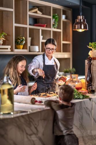 a woman is preparing food in a kitchen at Park Inn by Radisson Stuttgart in Stuttgart