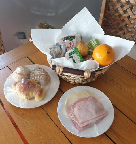a basket of food on a table with plates of food at São Bento na Alta in Coimbra
