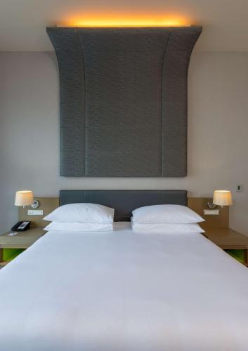 a bedroom with a large white bed with two pillows at Radisson Blu Hotel & Residence Maputo in Maputo