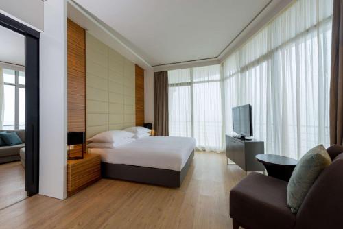 a hotel room with a bed and a tv at Radisson Blu Hotel & Residence Maputo in Maputo