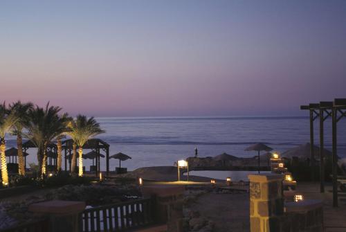 a view of the ocean from a resort at night at Radisson Blu Resort El Quseir in Quseir