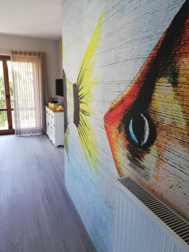 a wall with a peacock painting on it at Alex's home 2 in Crone