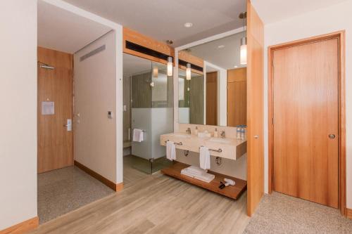 a bathroom with a sink and a mirror at Hotel Mio Vallarta Unique & Different- Adults Only in Puerto Vallarta