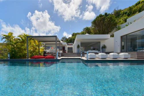 a villa with a swimming pool in front of a house at Dream Villa Flamands 744 in Anse des Cayes