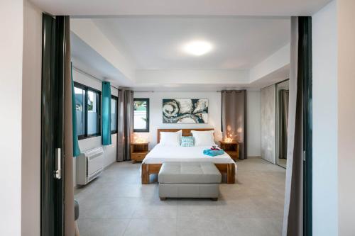 1 dormitorio con 1 cama y 1 silla en Dream Villa Lorient 604, en Saint Barthelemy