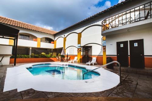 a swimming pool in the courtyard of a house at Del Mar Inn Playas in Tijuana