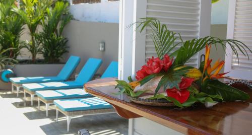 a table with a bouquet of flowers on it at LES HAUTS DU CAP in Le François