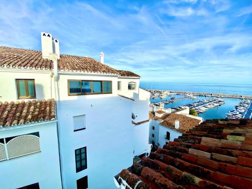 a view of a white building with a marina at Luxury Puerto Banus Penthouse With Parking & WI-FI in Marbella