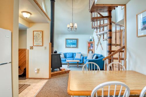 a dining room and living room with a table and chairs at The Chamberlain Chalet in Angel Fire