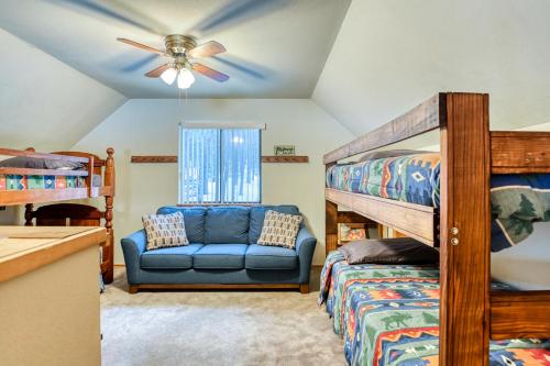 a bedroom with two bunk beds and a blue couch at The Chamberlain Chalet in Angel Fire
