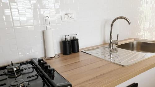 a kitchen counter with a sink and a stove at Apartment Amalia in Labin
