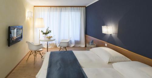 Säng eller sängar i ett rum på La Barca Blu