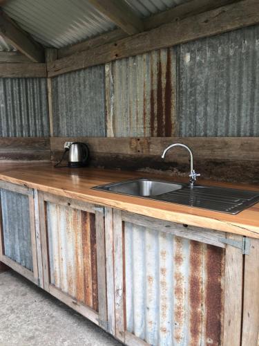 a kitchen counter with a sink in an outhouse at Daysy Hill Country Cottages in Port Campbell