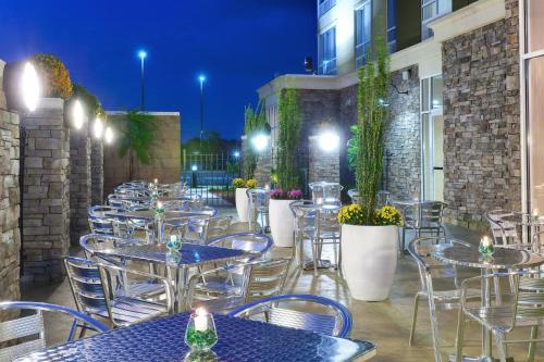 a row of tables and chairs on a patio at night at Holiday Inn Southaven Central - Memphis by IHG in Southaven