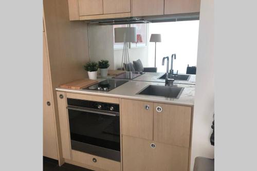 a kitchen with a sink and a stove at The Watson 209 great location Close to CBD in Adelaide