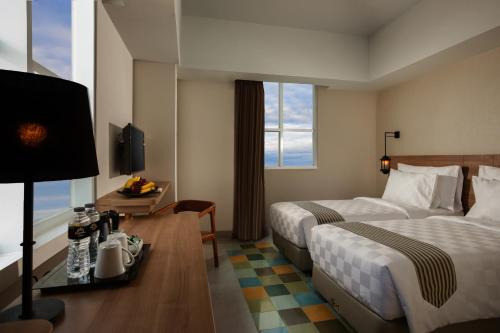 Ένα ή περισσότερα κρεβάτια σε δωμάτιο στο KHAS Tugu Hotel Yogyakarta