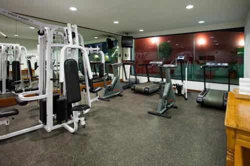 a gym with several tread machines in a room at Holiday Inn Puebla La Noria by IHG in Puebla